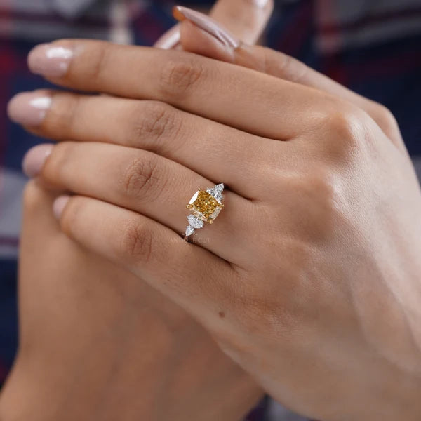 Three stone inspired yellow diamond engagement ring with side diamonds