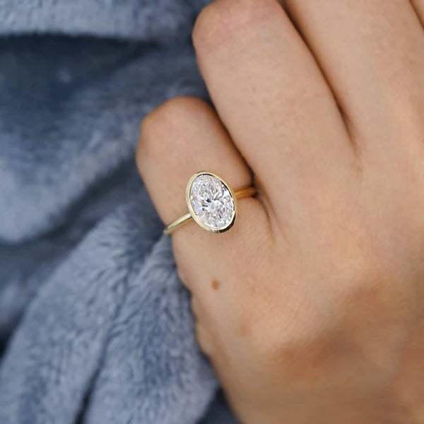 Yellow gold bezel set oval diamond ring