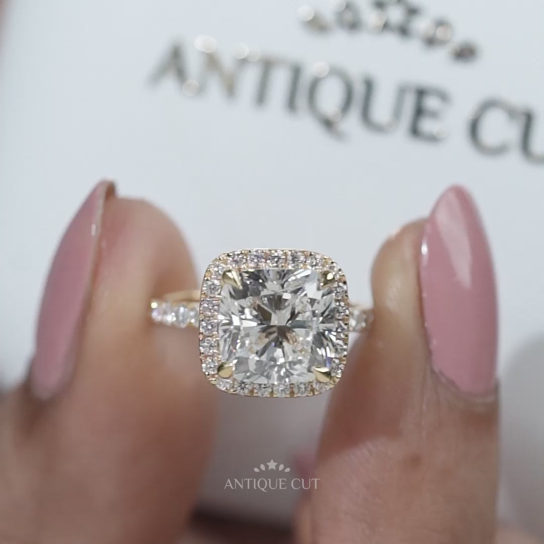 Yellow gold cushion halo diamond engagement ring with pave band