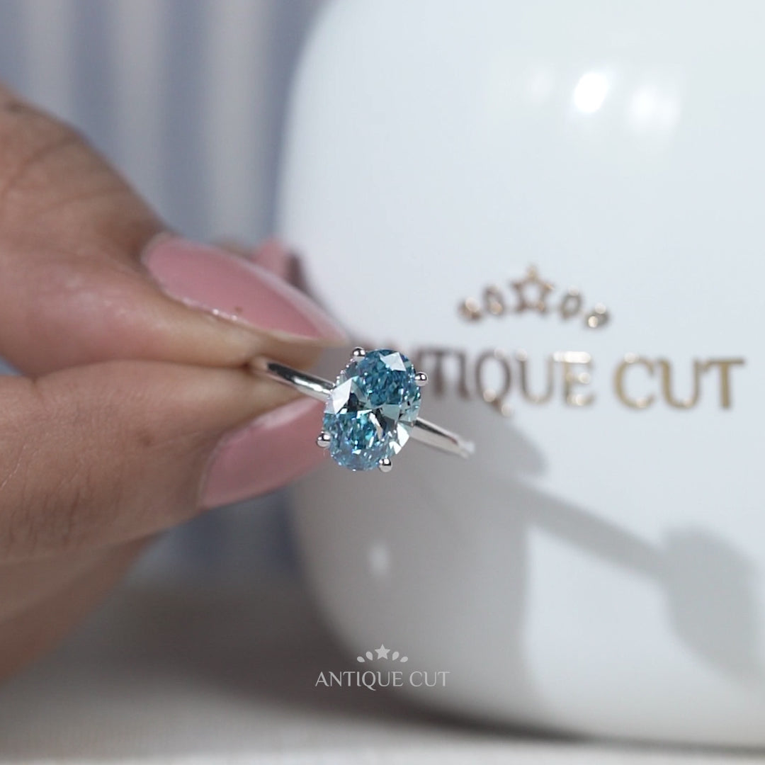 White gold blue diamond solitaire ring hidden halo design