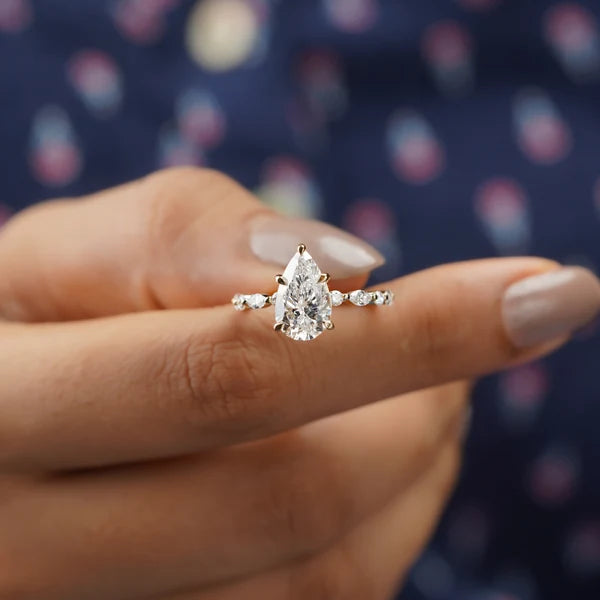 Yellow gold pear diamond engagement ring with side stones
