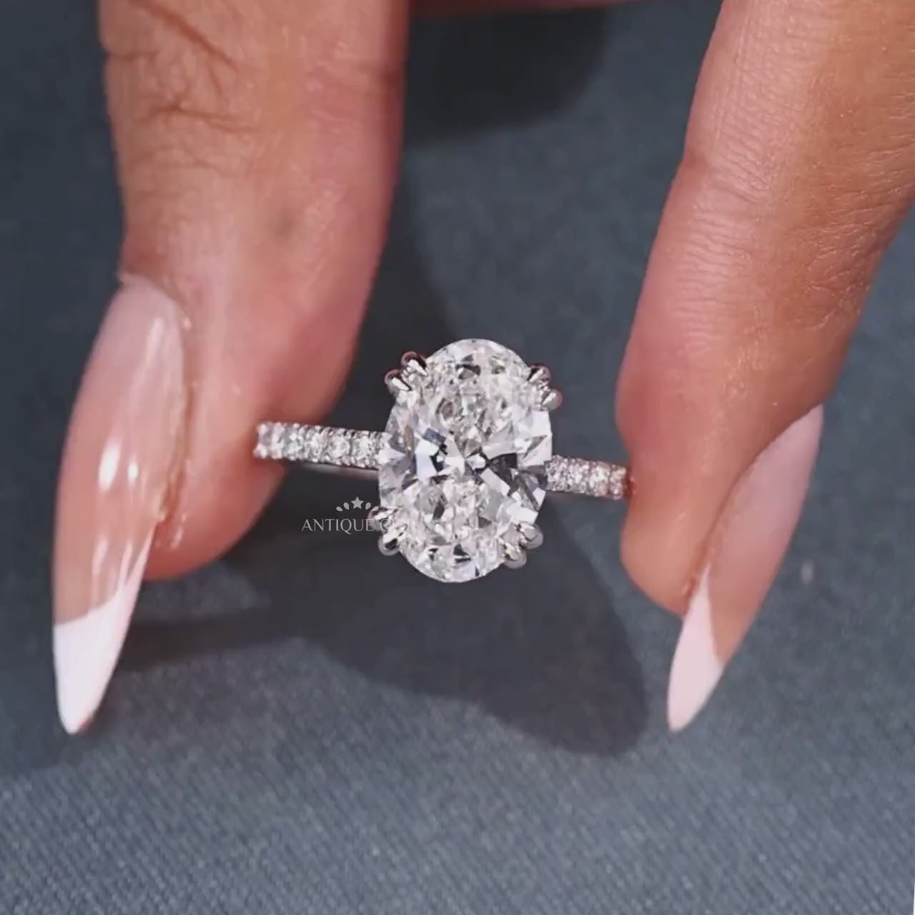 Oval cut diamond ring with 4 round prong setting and marquise accents
