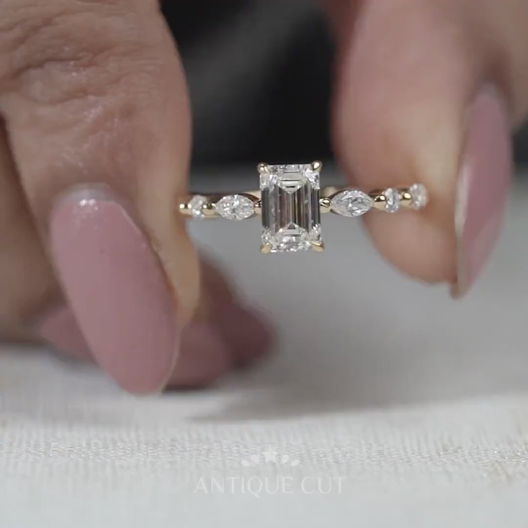 Yellow gold emerald diamond ring with round and marquise accents