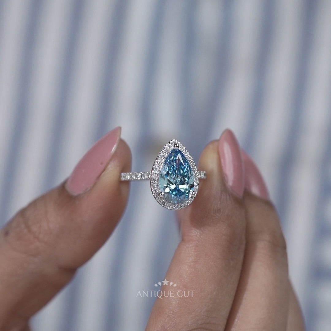 White gold blue pear diamond engagement ring halo design