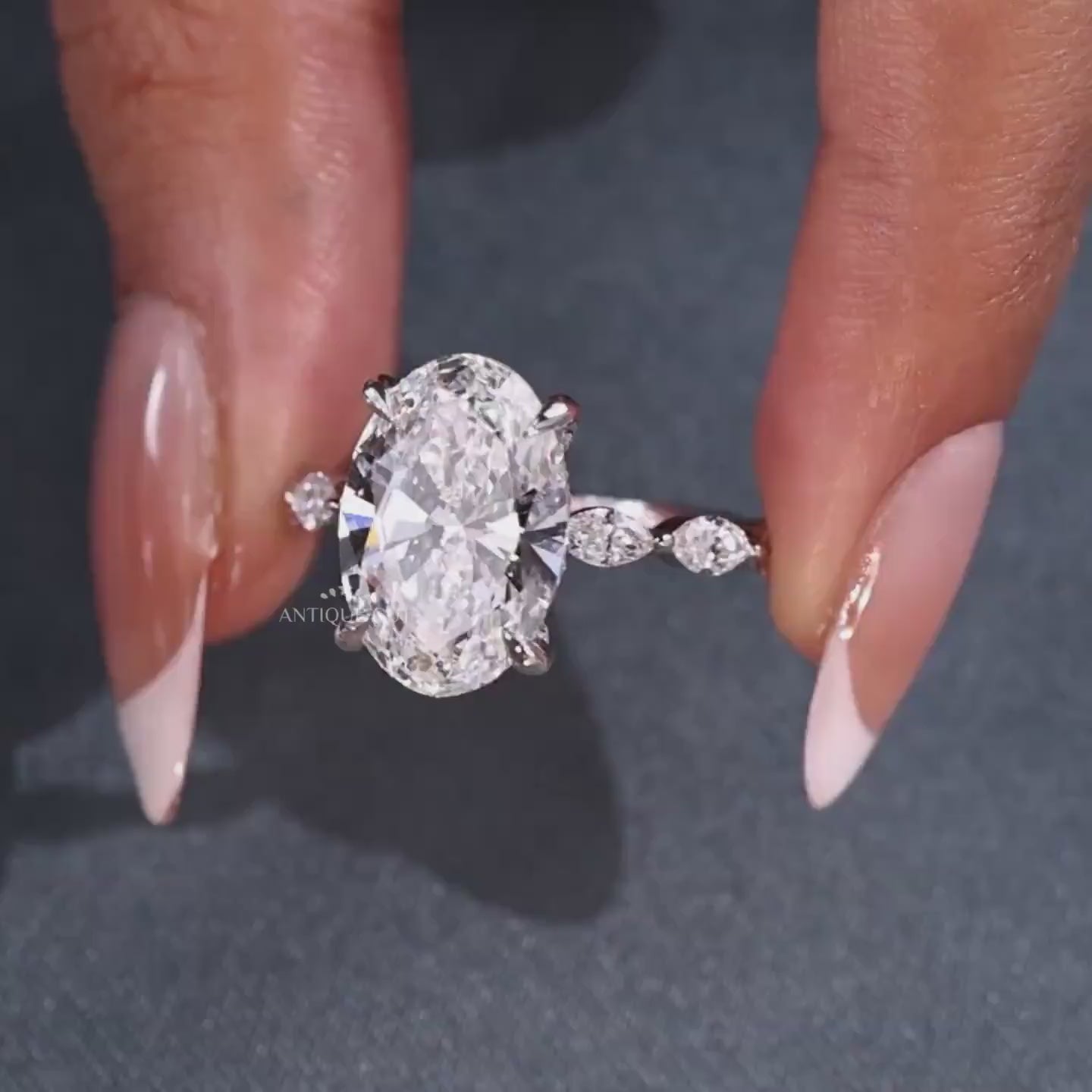 5 carat oval diamond engagement ring with marquise cut pavé band
