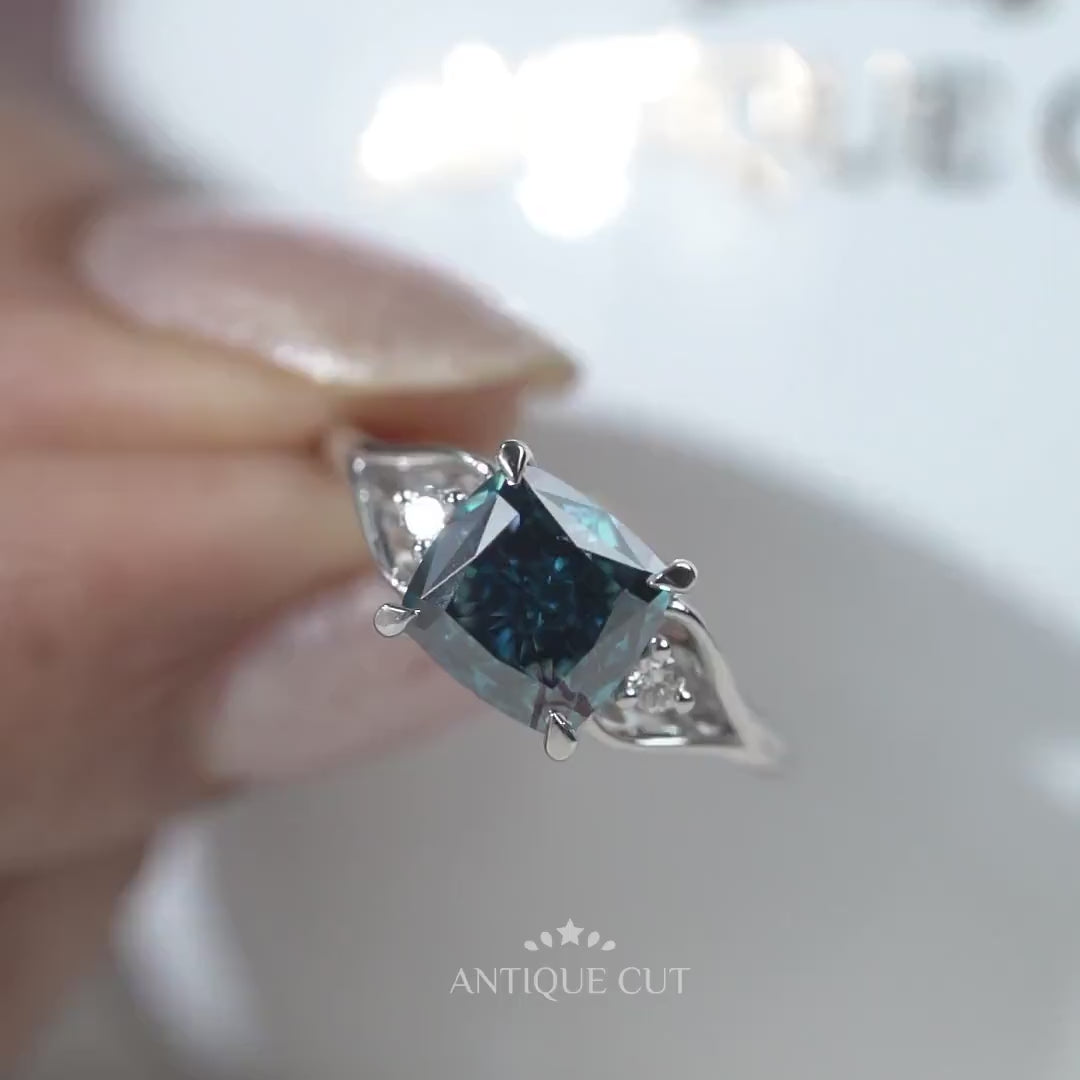 Elegant cushion cut blue diamond engagement ring with side stones