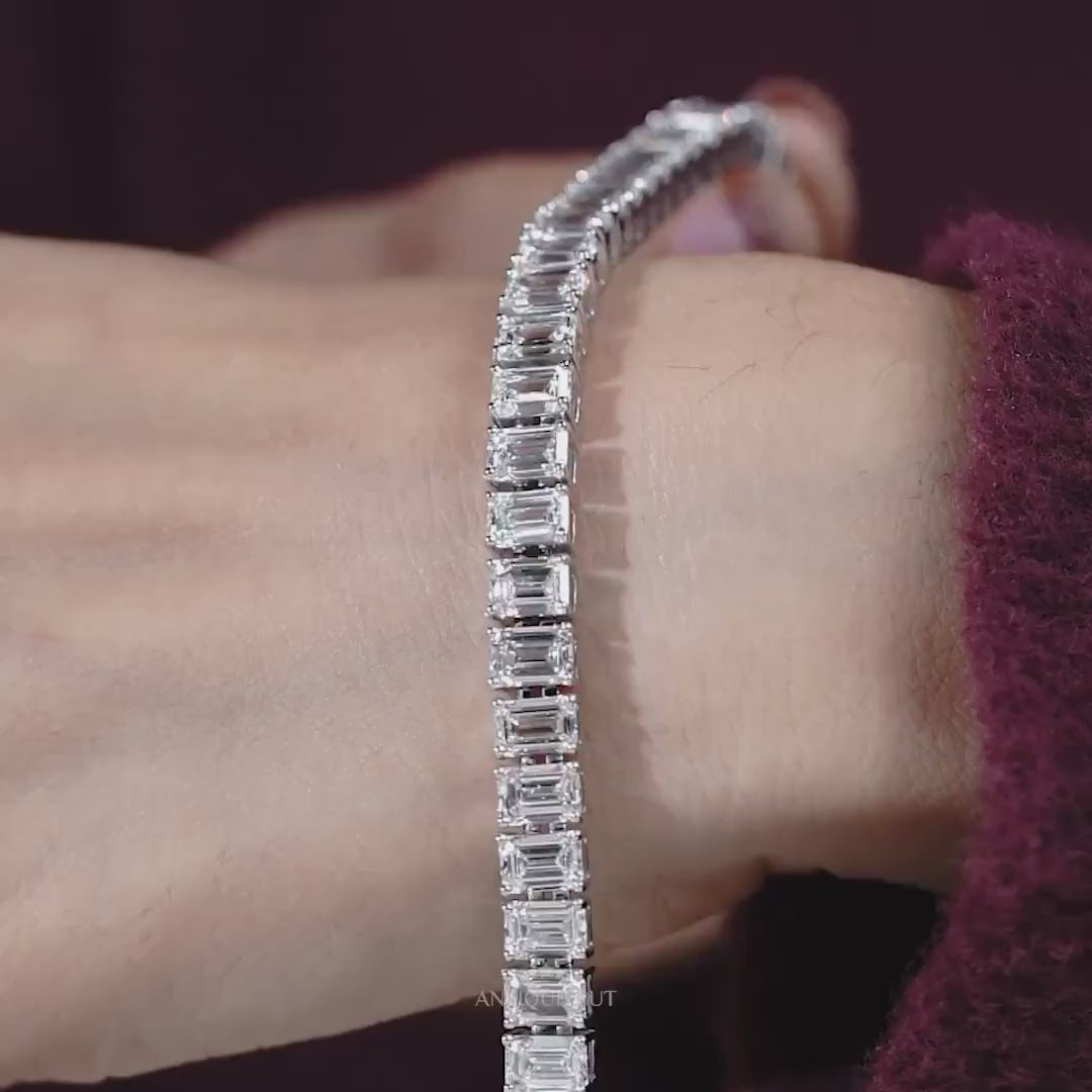 Silver bracelet with square-cut stones on a light gray background