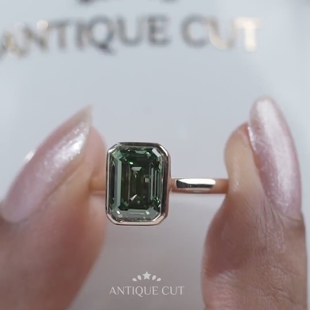 Lab grown emerald cut green sapphire engagement ring