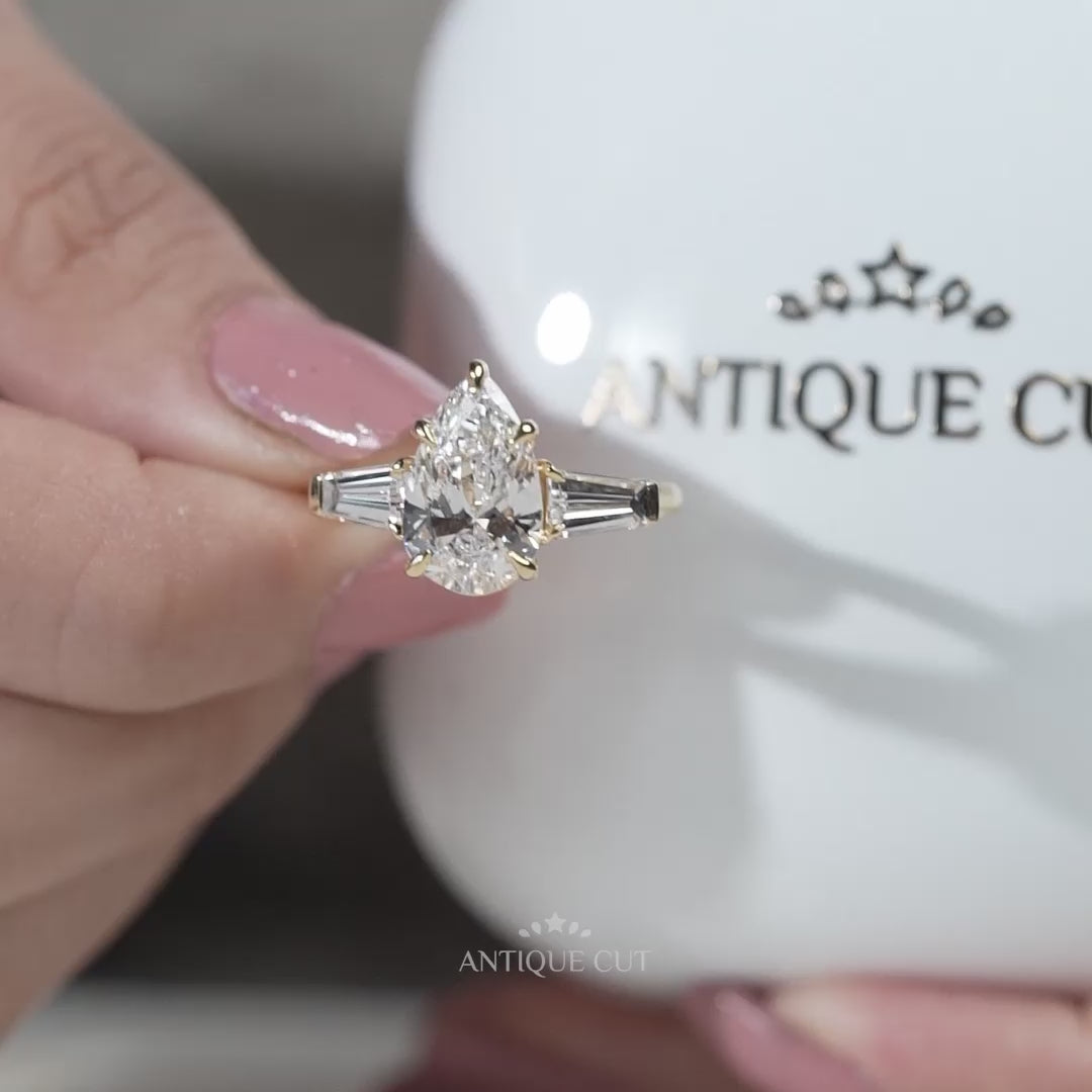 Yellow gold pear diamond engagement ring with baguette side stones