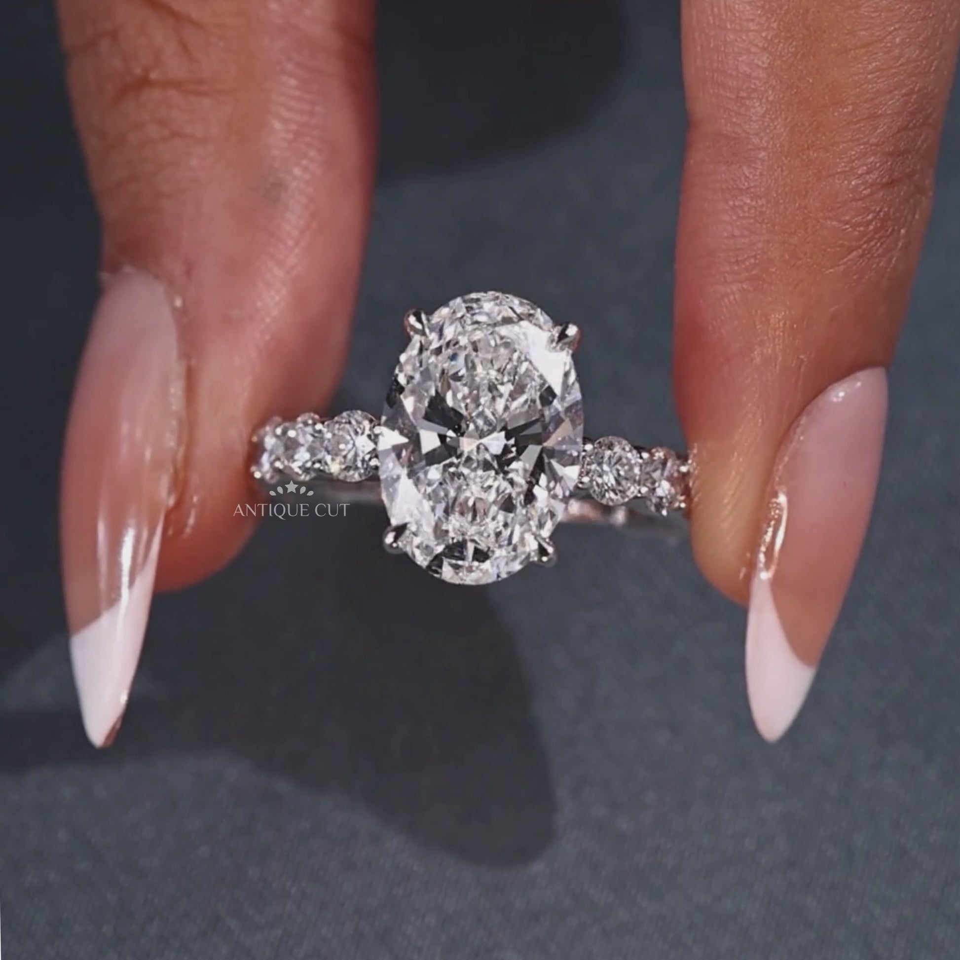 Oval lab grown diamond ring with four claw prongs
