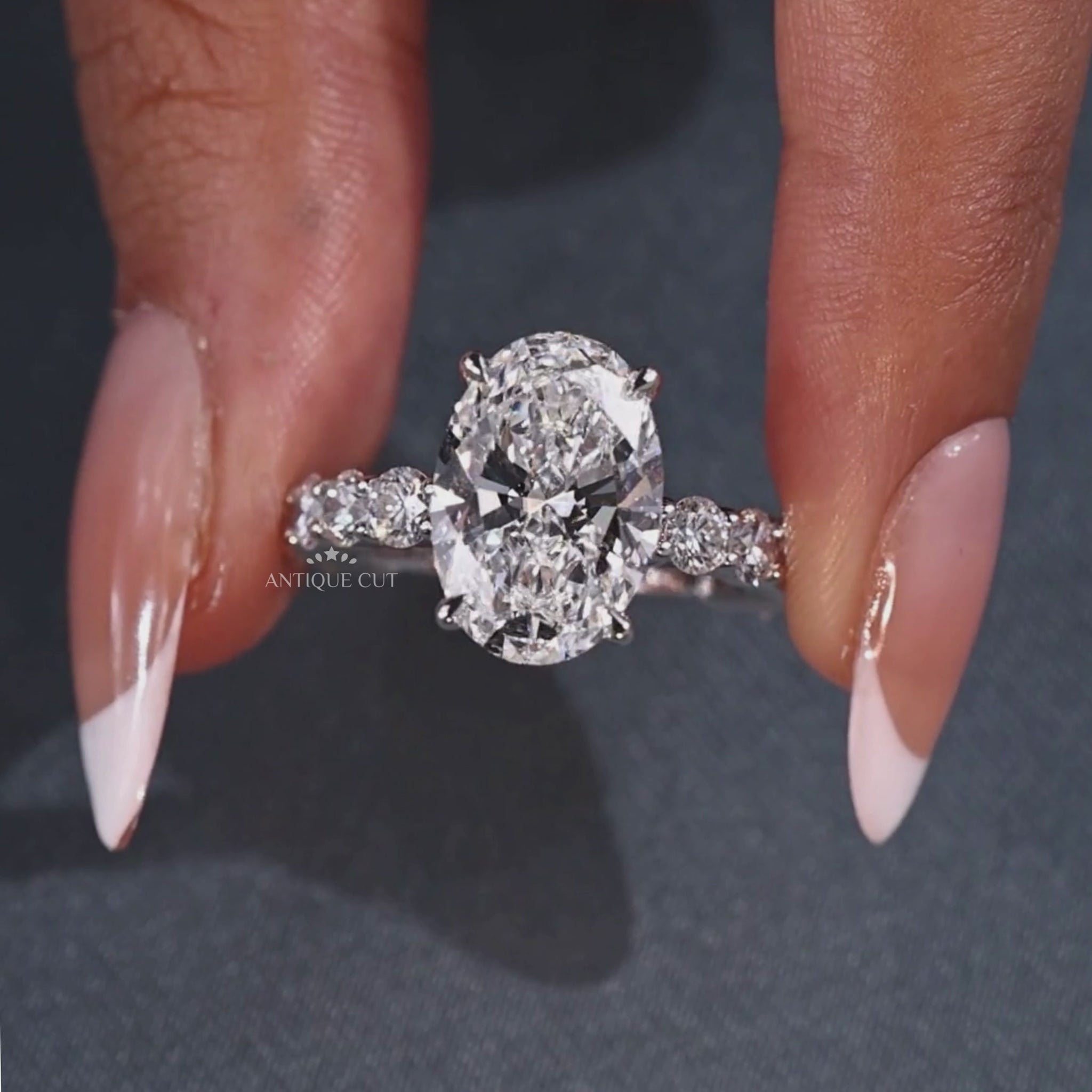 Oval lab grown diamond ring with four claw prongs
