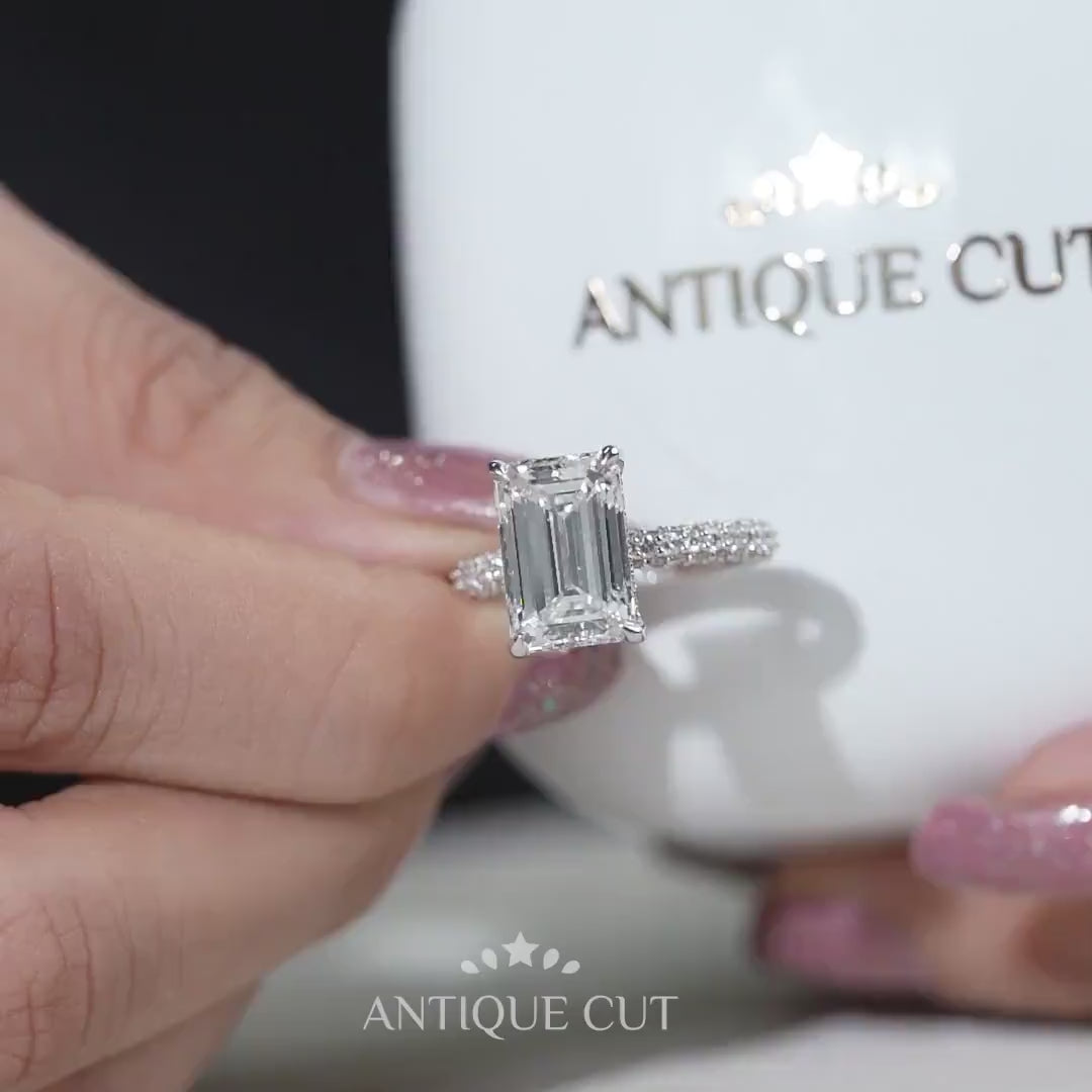 White gold emerald cut engagement ring with pave band