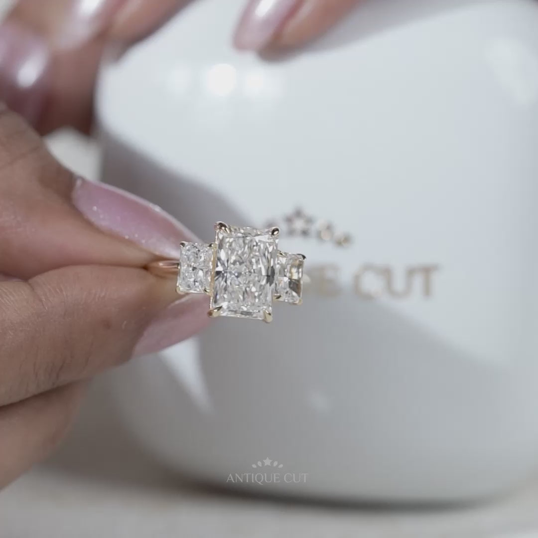 Three stone radiant cut engagement ring in white gold