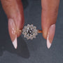 Round cut diamond halo ring with floral design