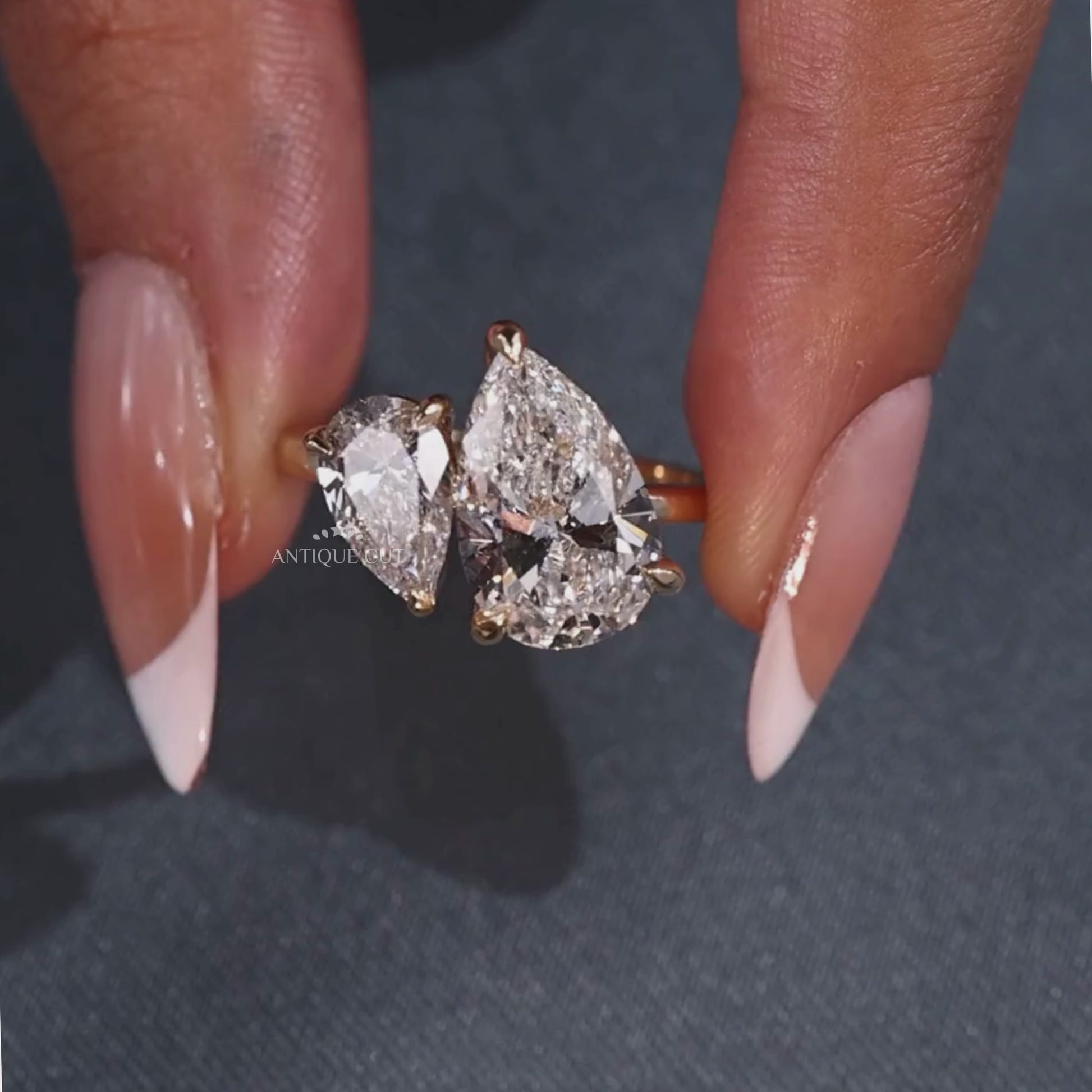 Pear shaped toi et moi engagement ring with claw prong setting