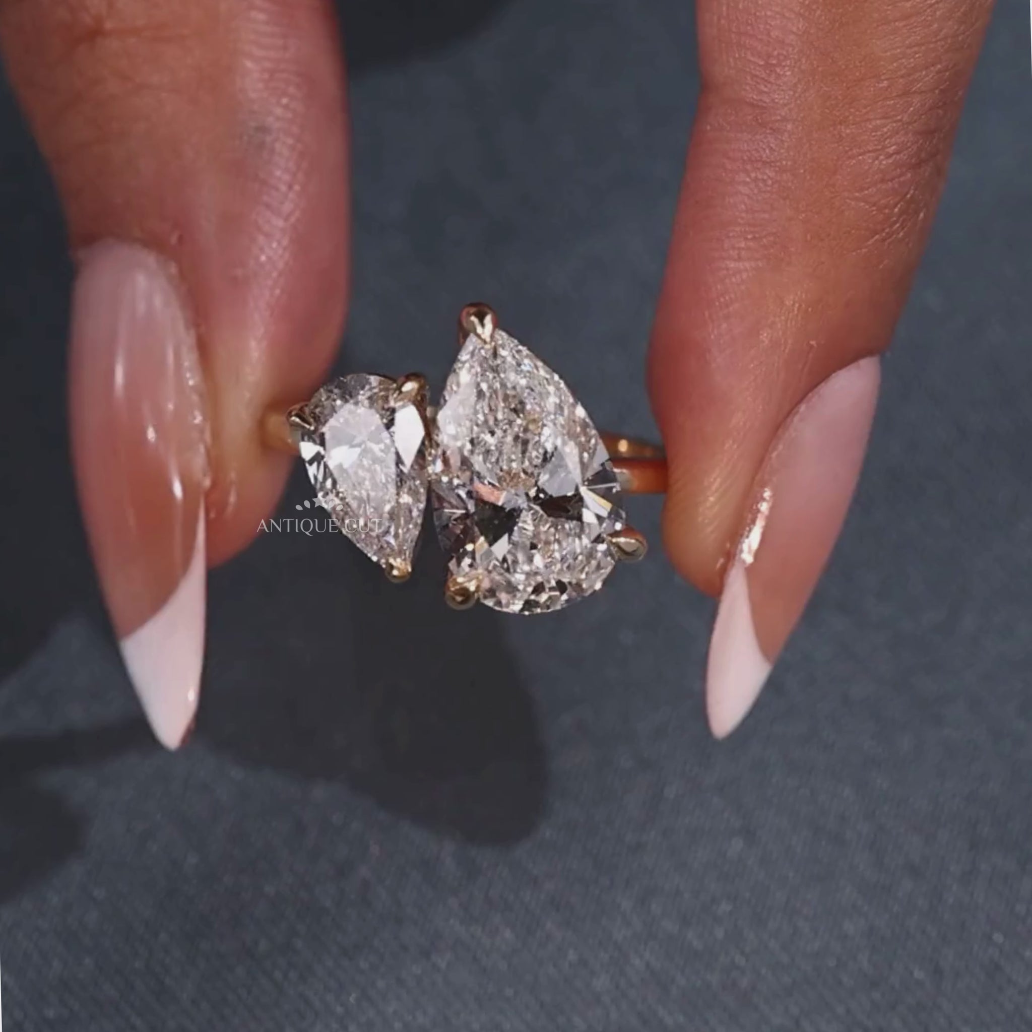 Pear shaped toi et moi engagement ring with claw prong setting