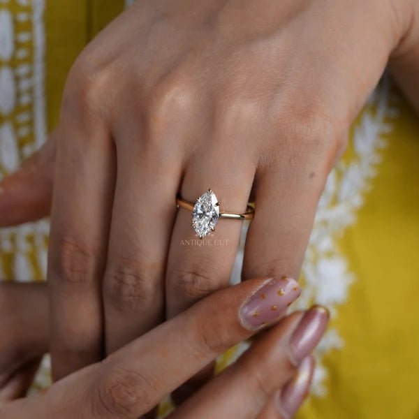 Marquise cut diamond solitaire engagement ring in yellow gold