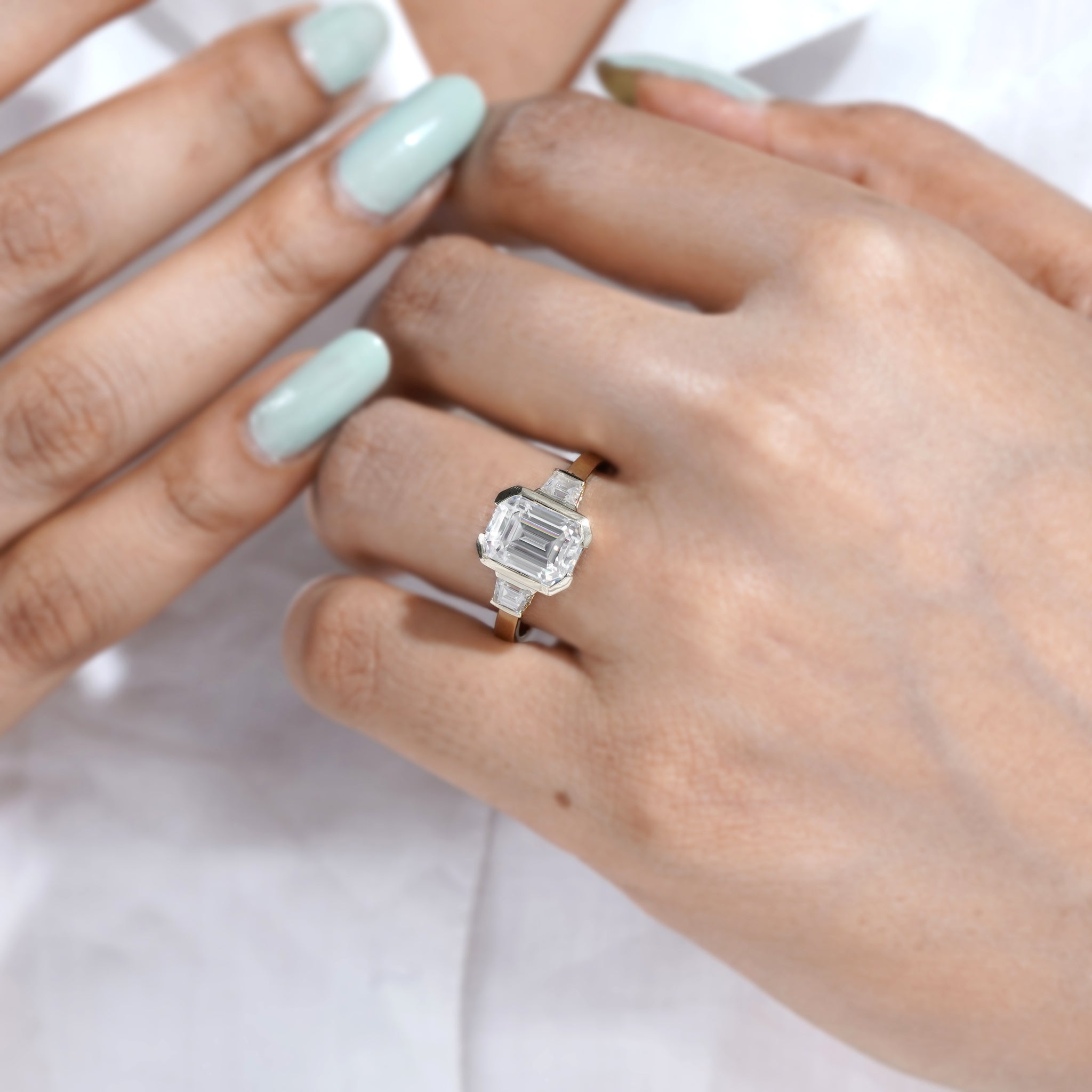 Yellow gold emerald cut three stone diamond ring