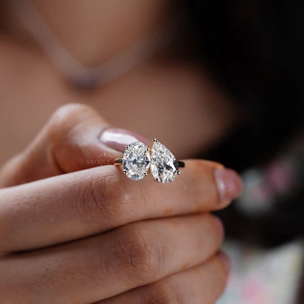 Oval and pear diamond toi et moi engagement ring in yellow gold