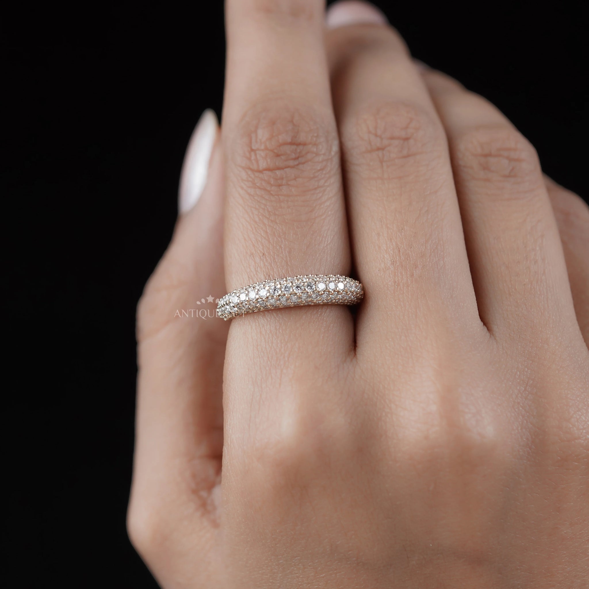 Luxury pave set diamond band crafted in yellow gold with a low profile design.