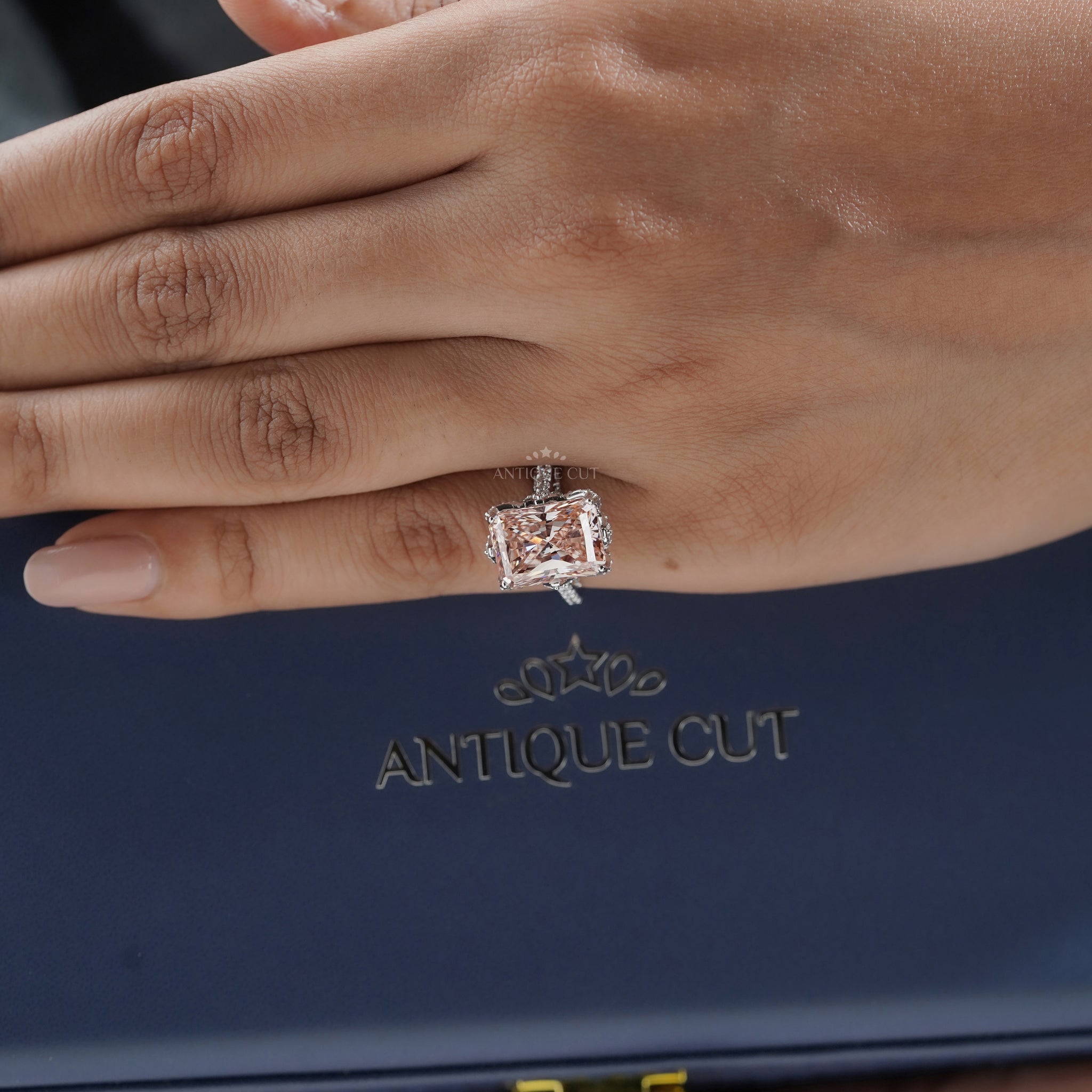 Radiant cut pink diamond halo engagement ring with pavé band