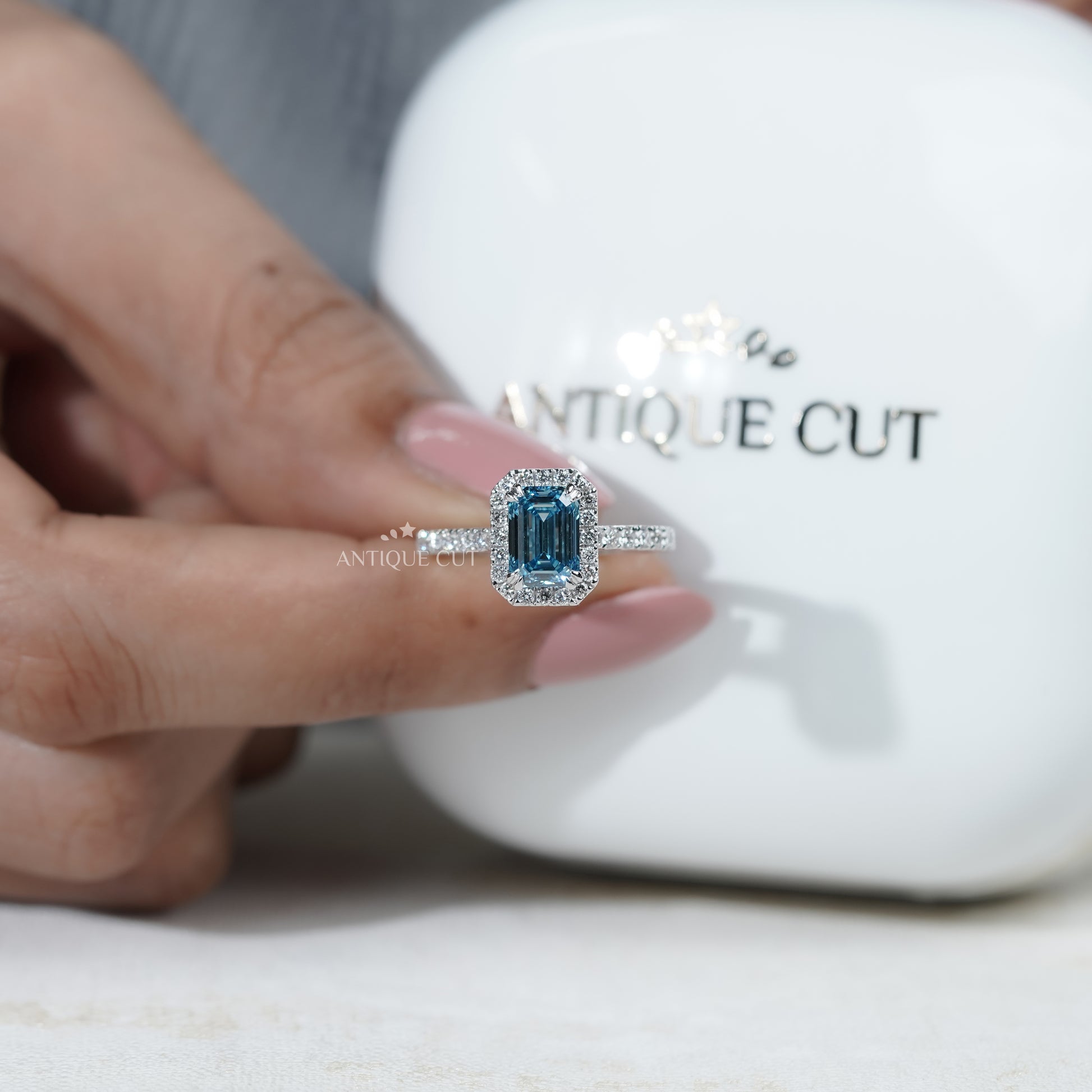 White gold fancy blue diamond engagement ring emerald halo