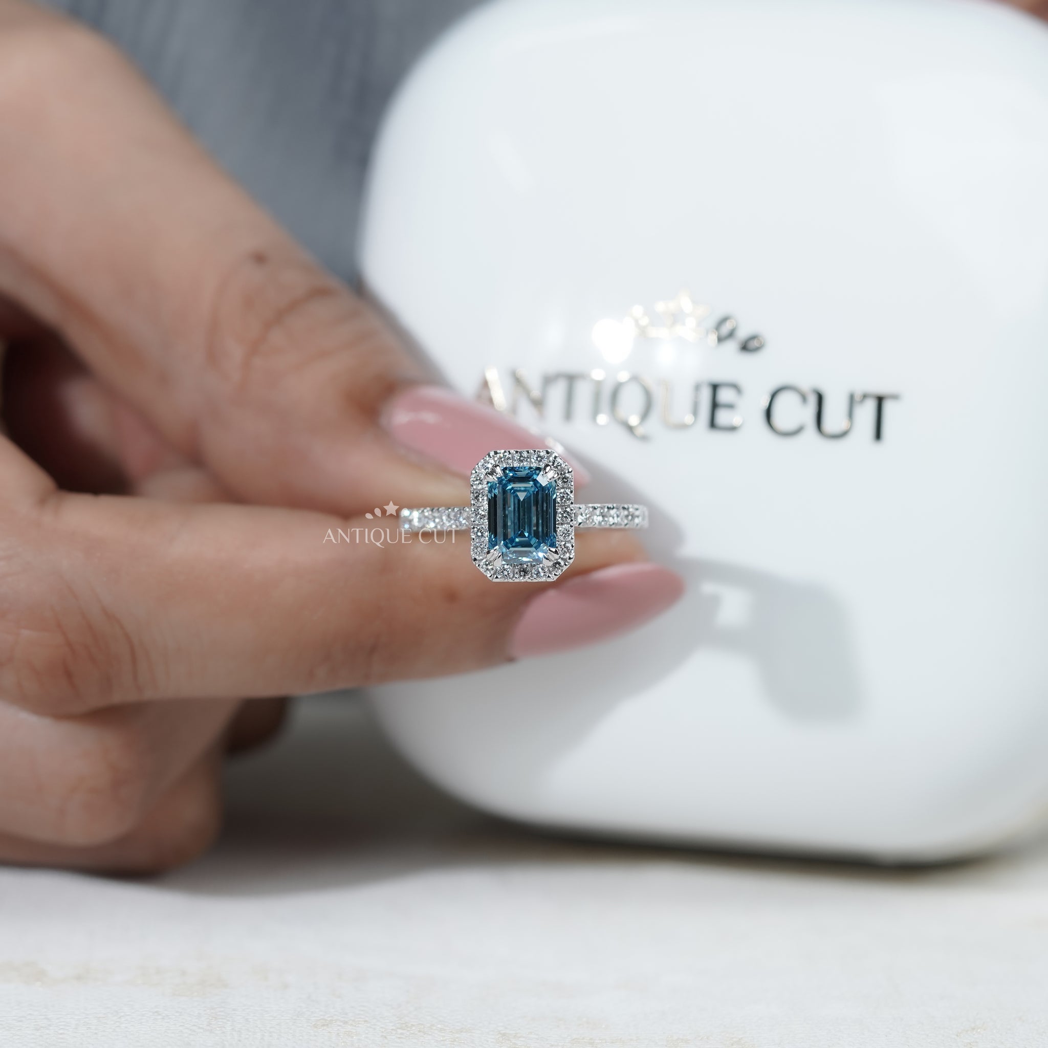 White gold fancy blue diamond engagement ring emerald halo