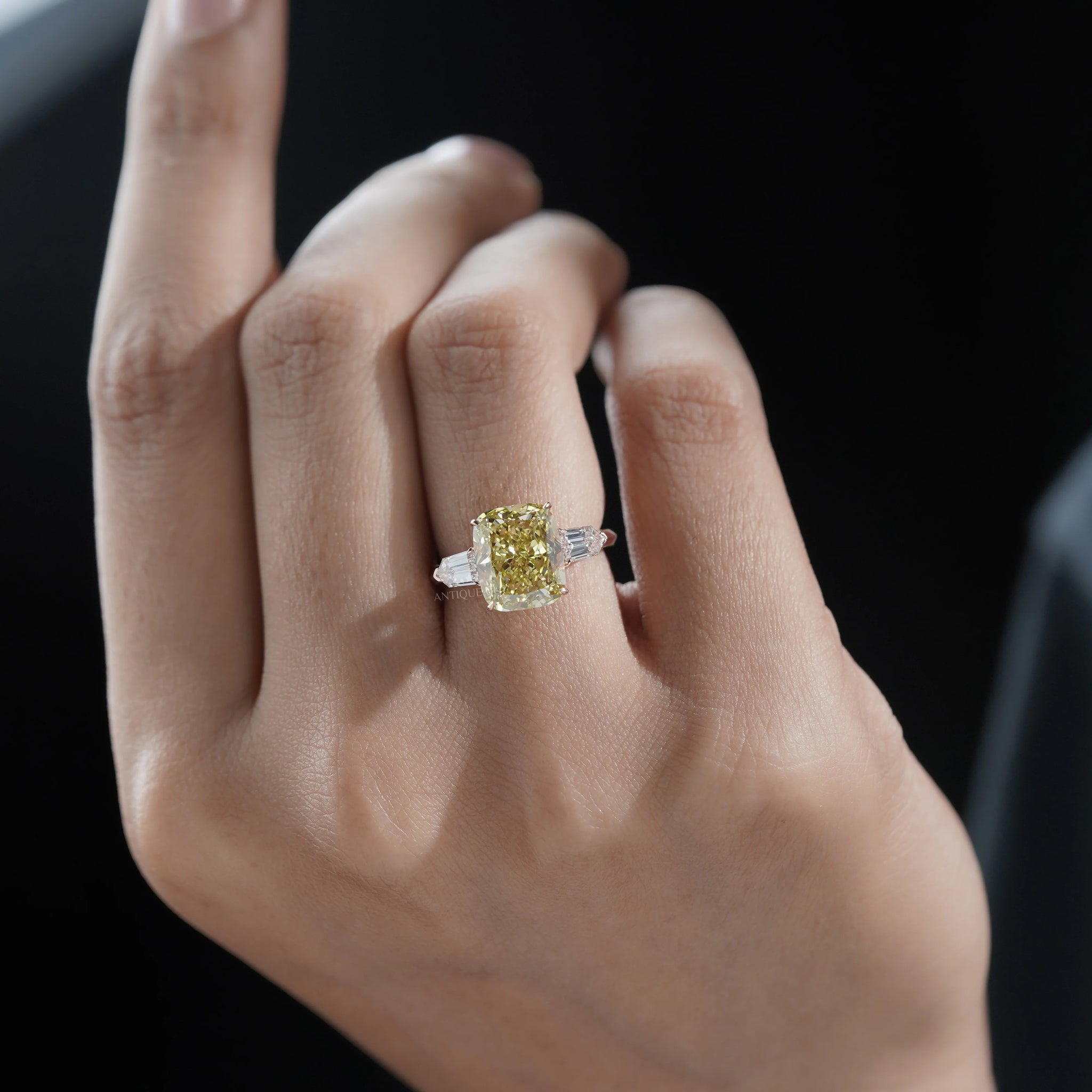 Fancy yellow radiant cut diamond engagement ring with baguette side stones