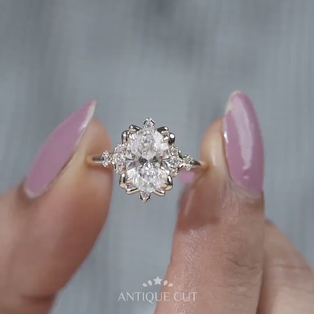 Oval lab grown diamond engagement ring with floral halo and claw prong setting in yellow gold