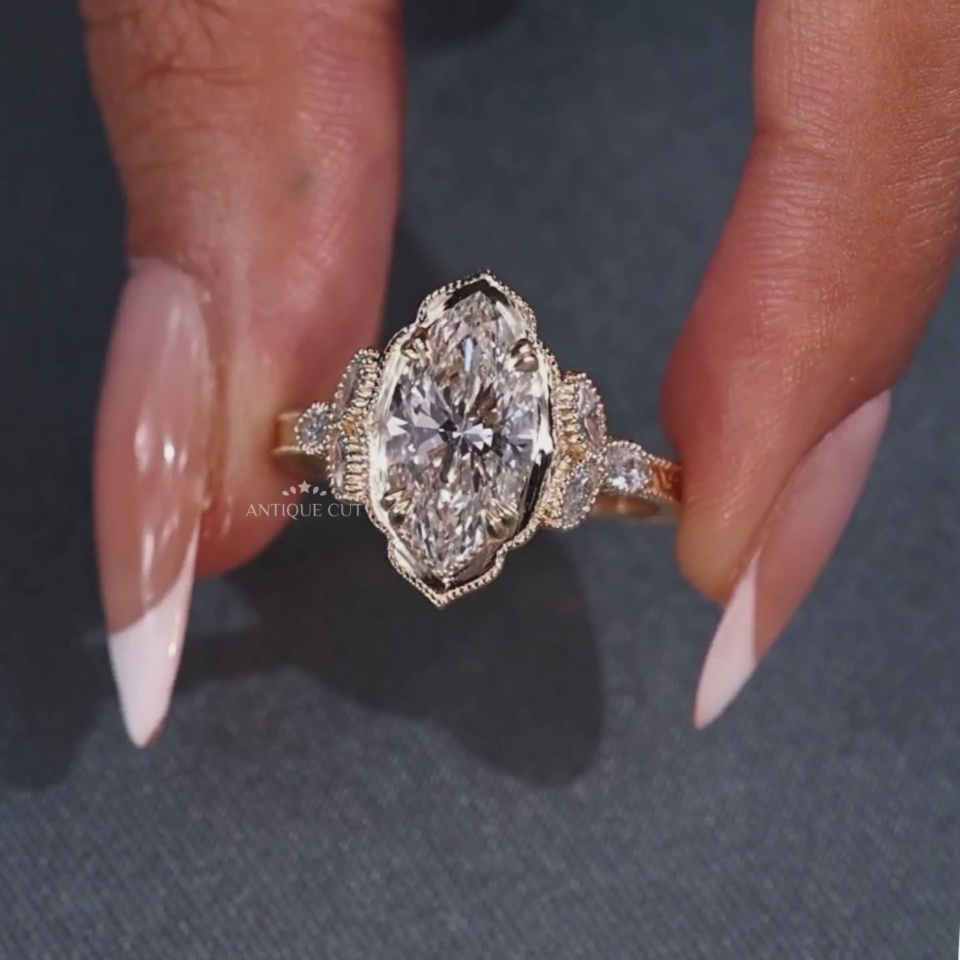 Marquise cut engagement ring with three side stones
