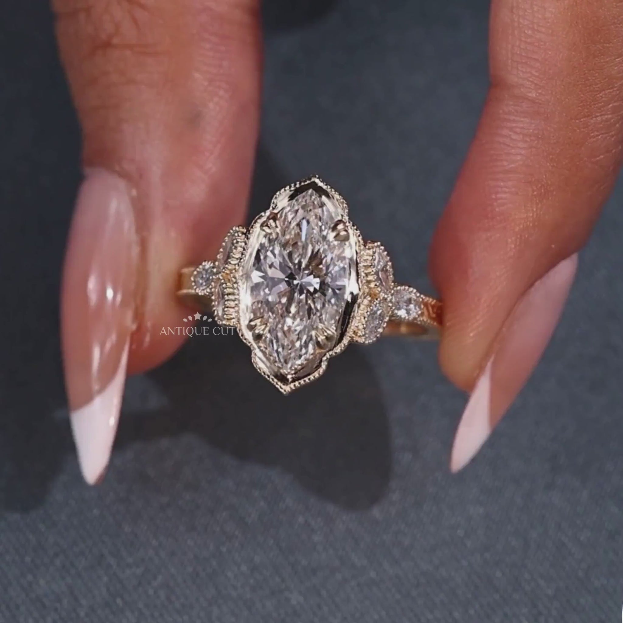 Marquise cut engagement ring with three side stones
