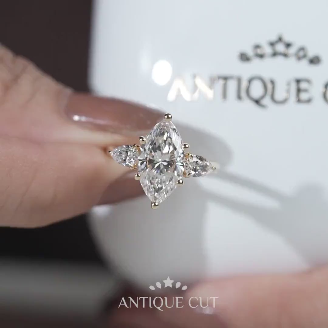 Yellow gold marquise diamond ring with side stones