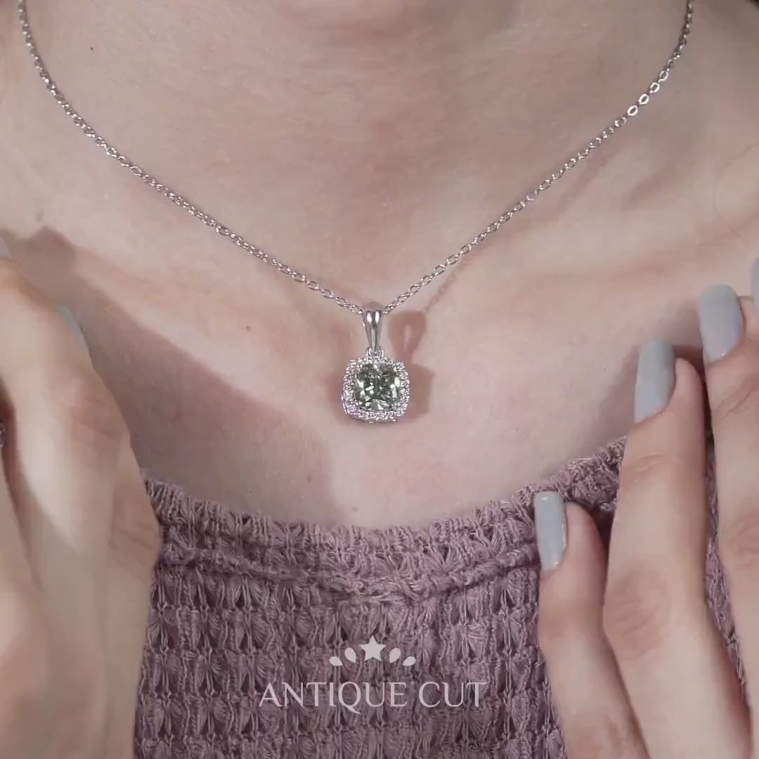 Close up of cushion cut green halo pendant