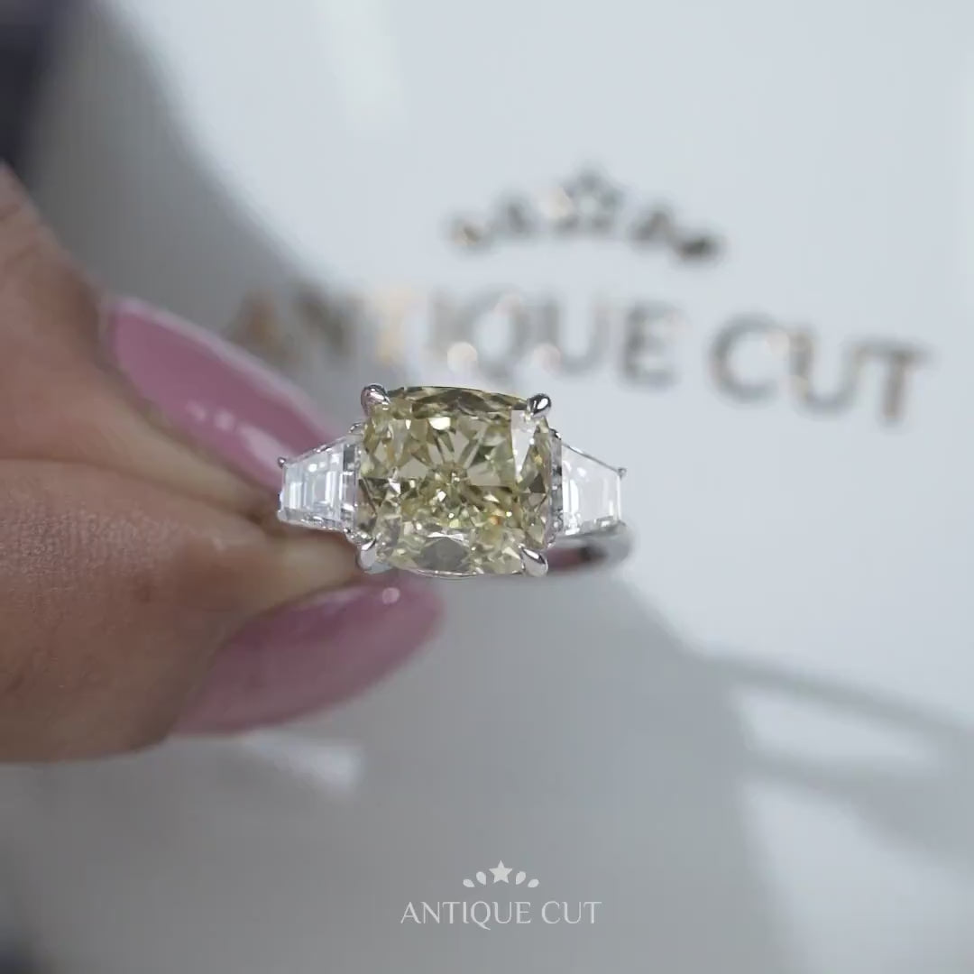 Classic cushion cut yellow diamond ring with tapered baguette sides