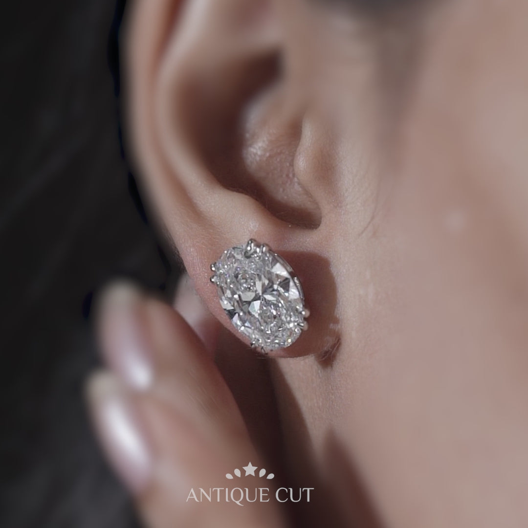 Front view of oval diamond stud earrings with claw double prongs