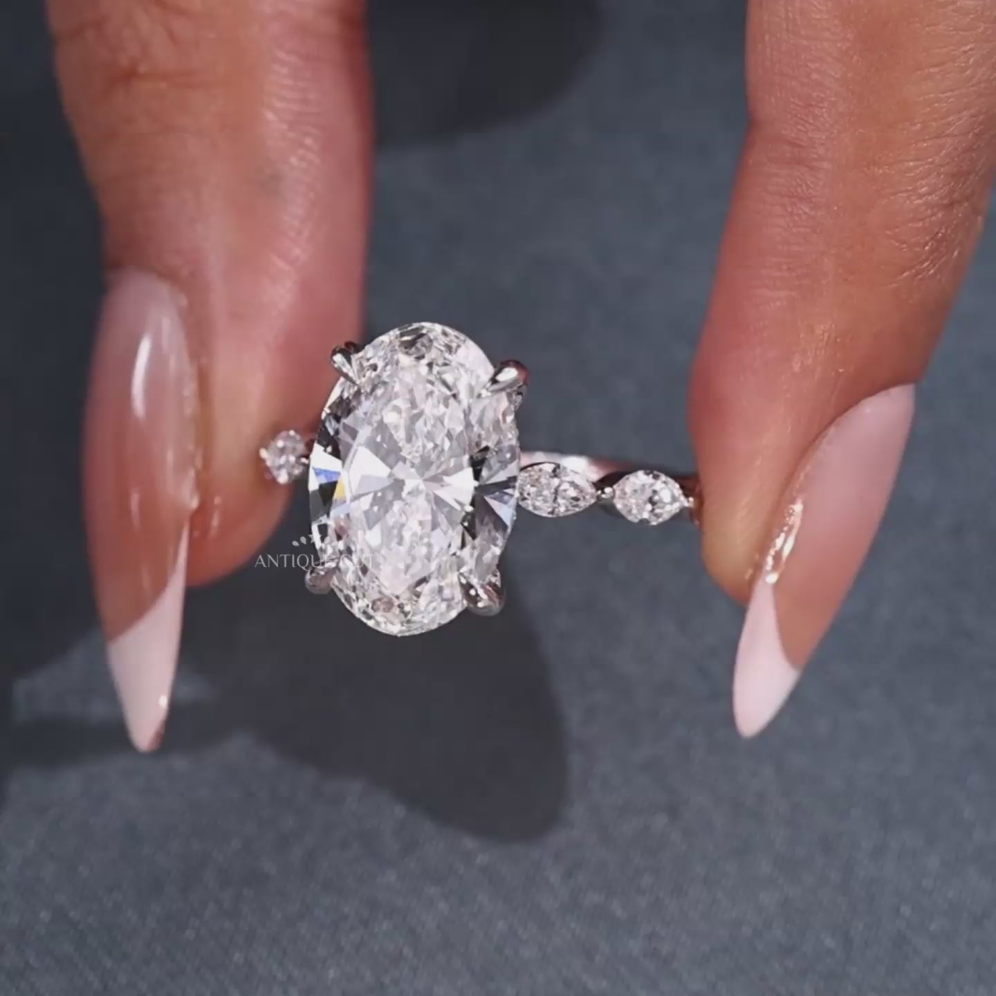 Hidden halo oval engagement ring with marquise accents