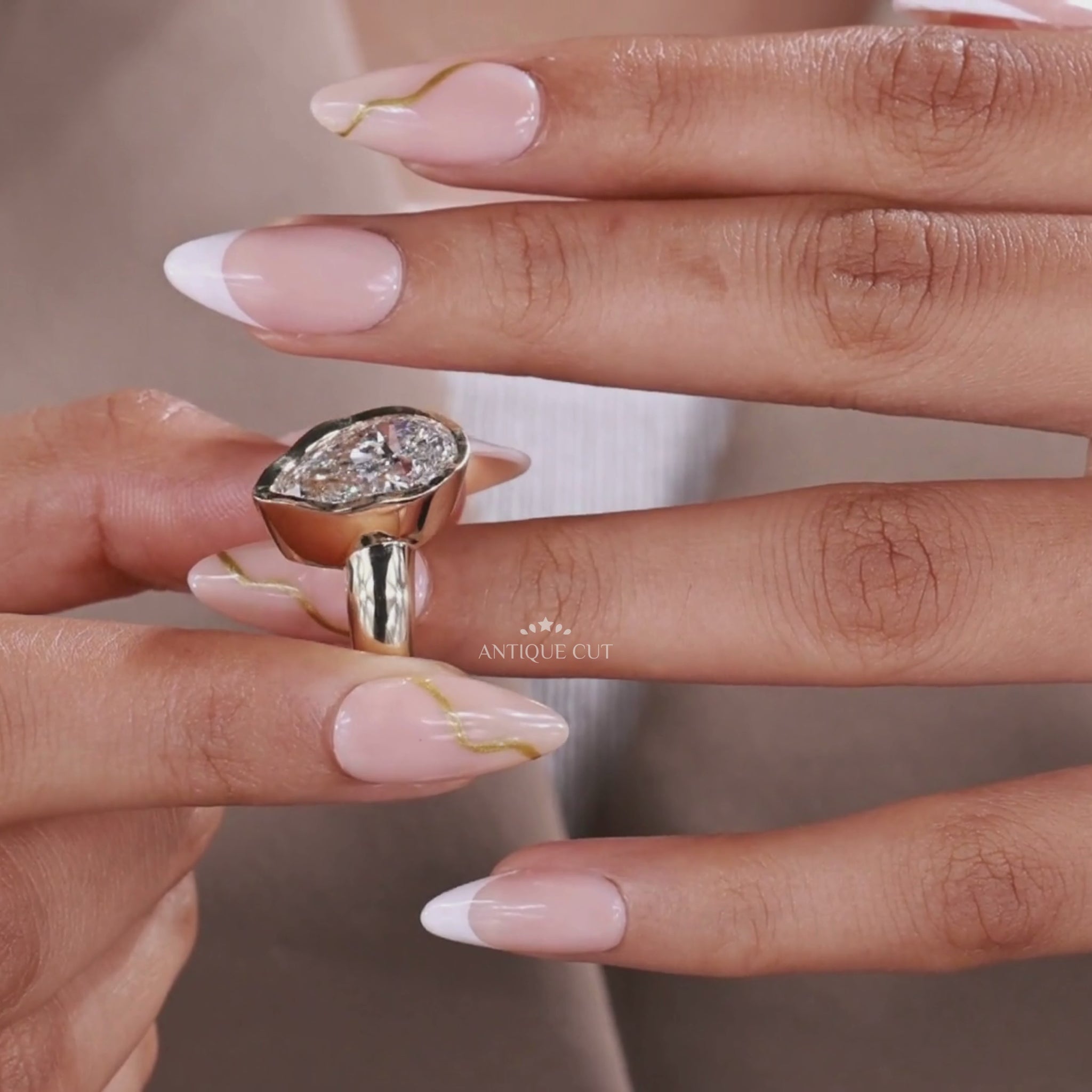Pear lab grown diamond ring featuring a bezel setting and yellow gold design