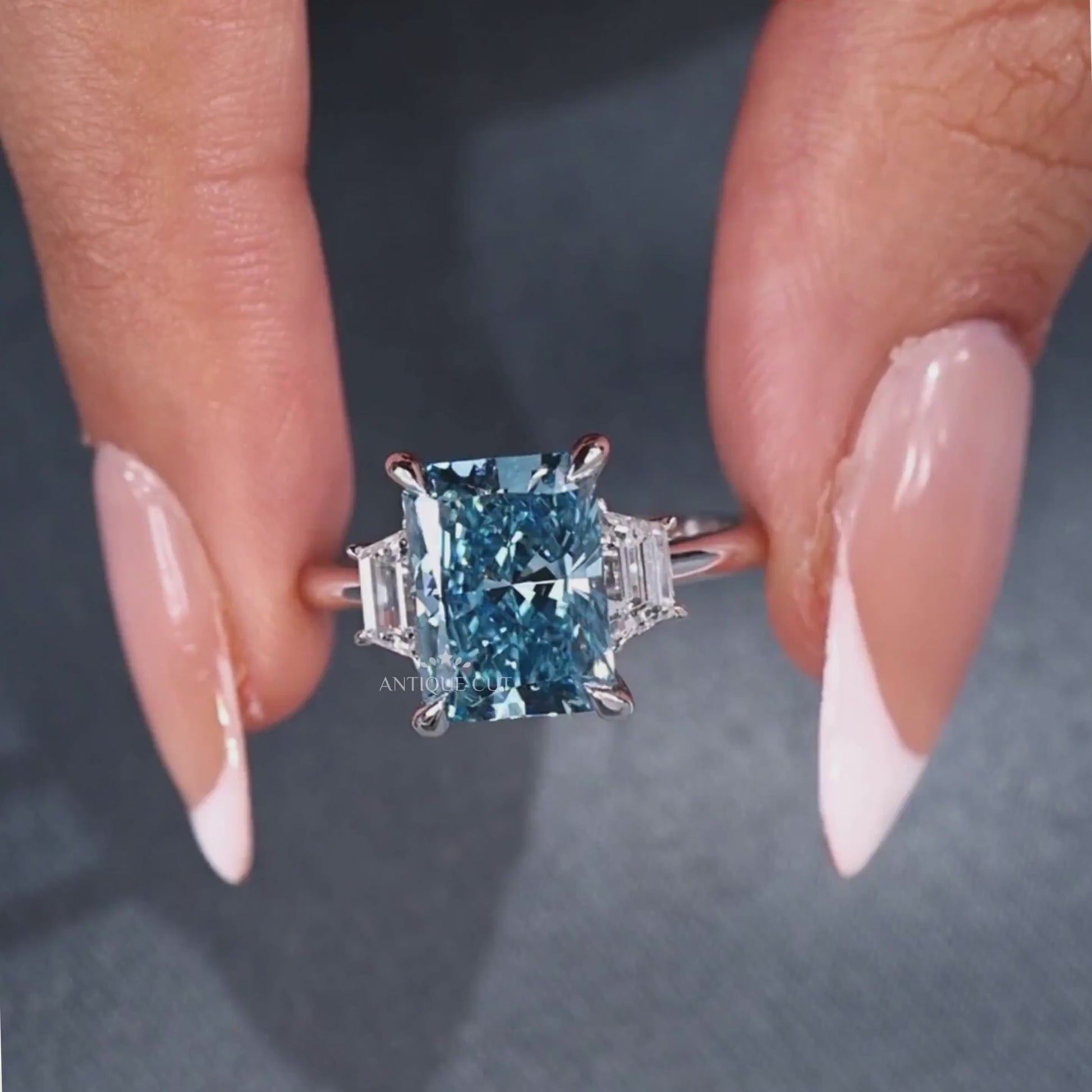 Radiant cut blue diamond engagement ring with cathedral setting