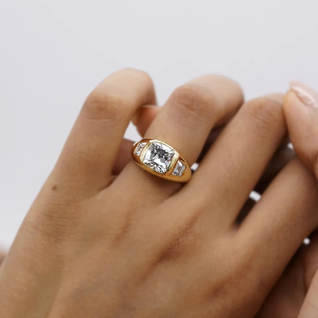 Yellow gold old mine cushion diamond three stone ring