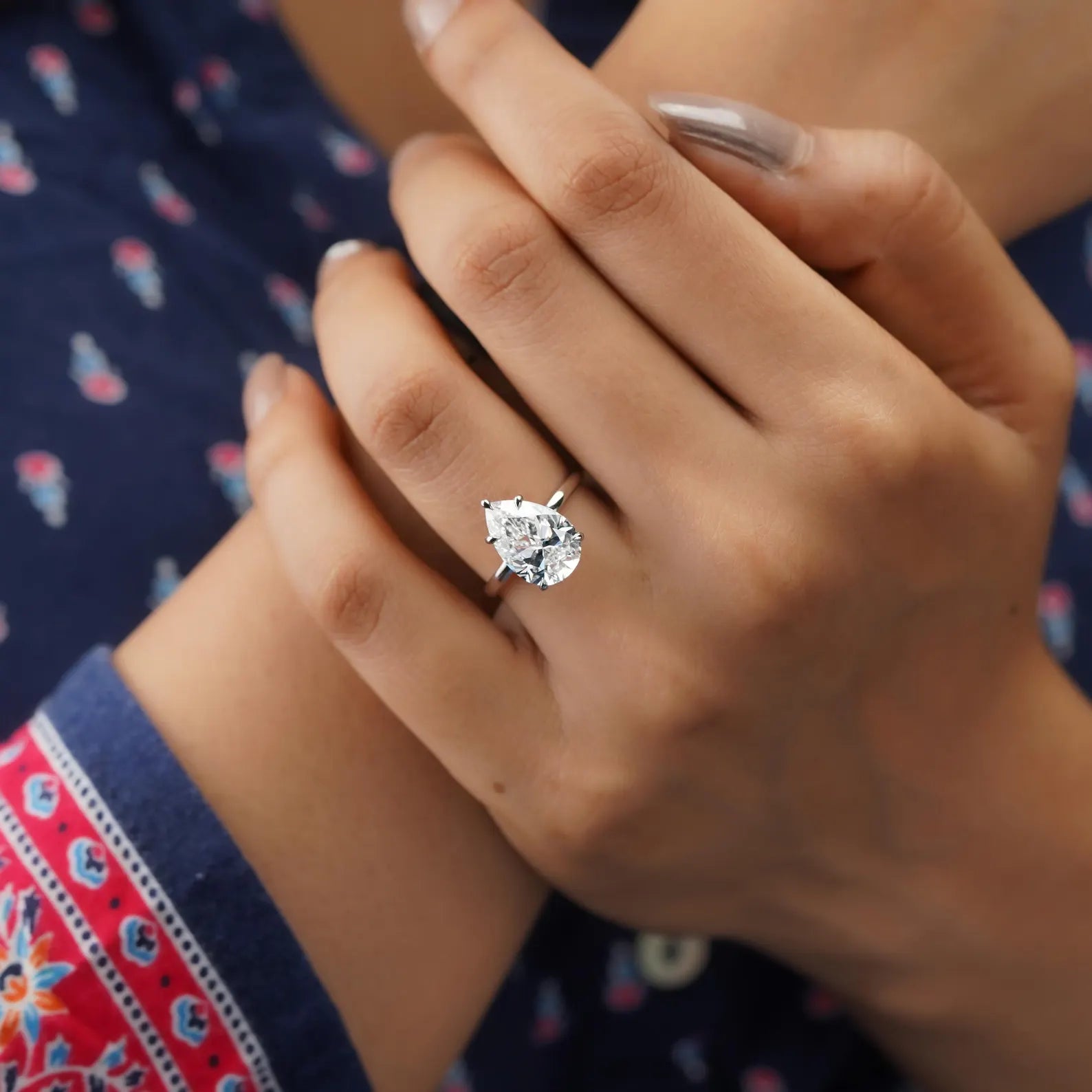 White gold pear diamond ring with hidden halo