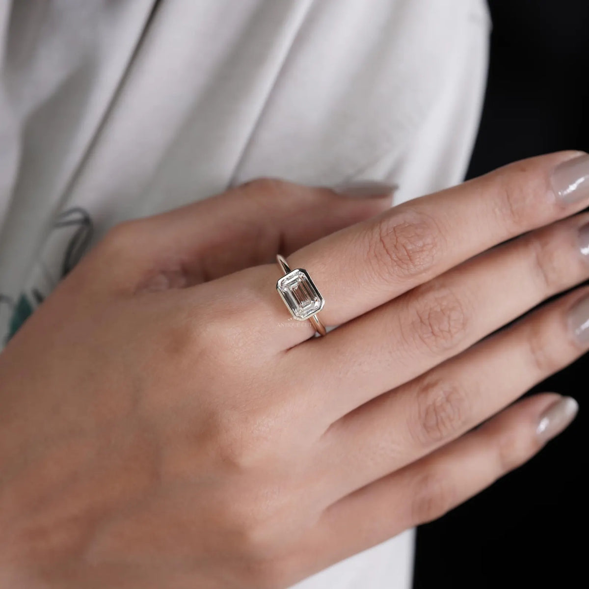 Emerald cut east west diamond engagement ring