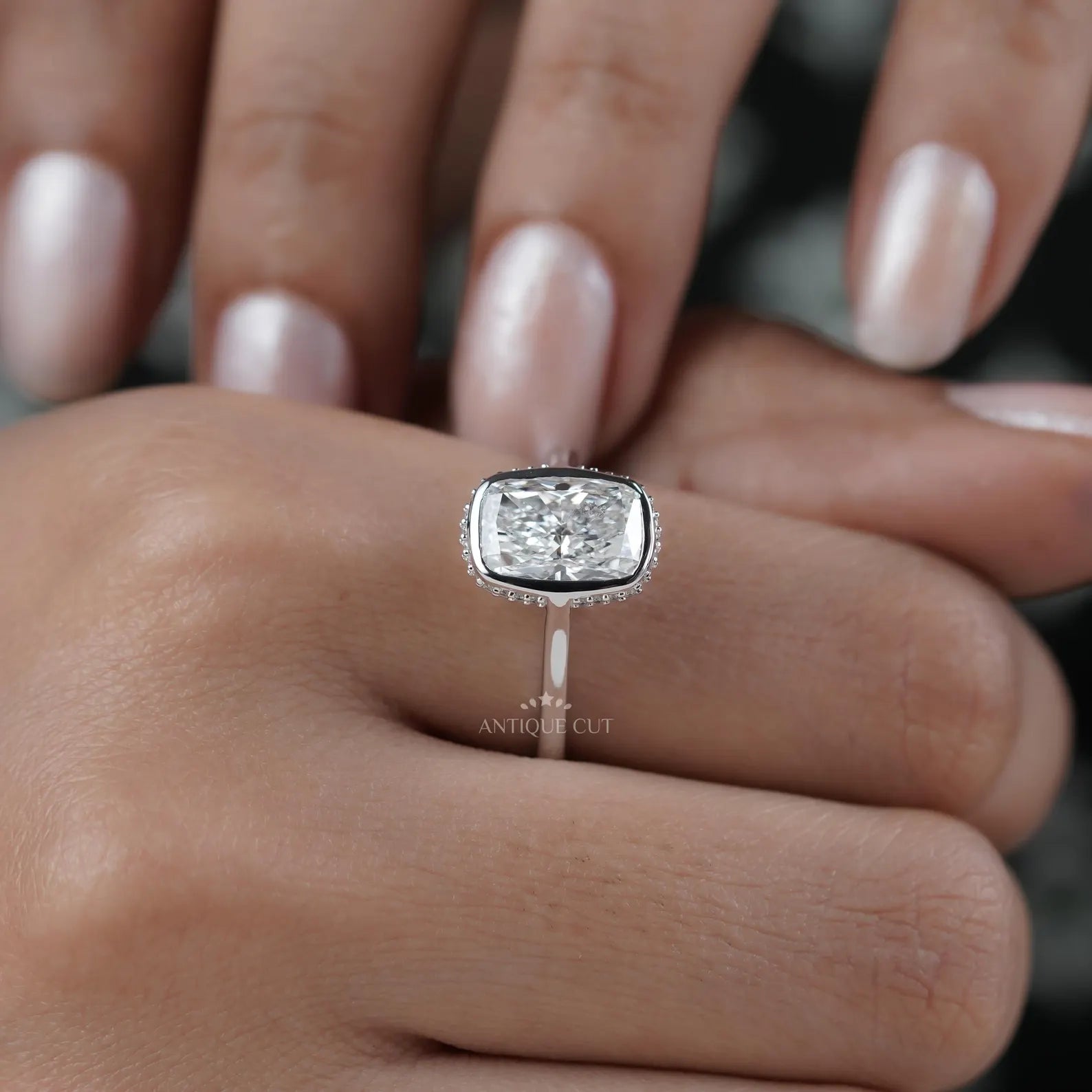 White gold cushion halo engagement ring close up