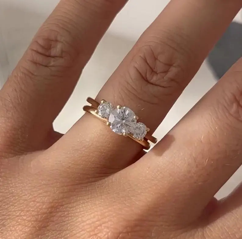 Round cut diamond engagement ring with two round side stones