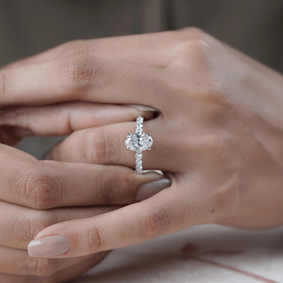 Oval diamond engagement ring with pave band
