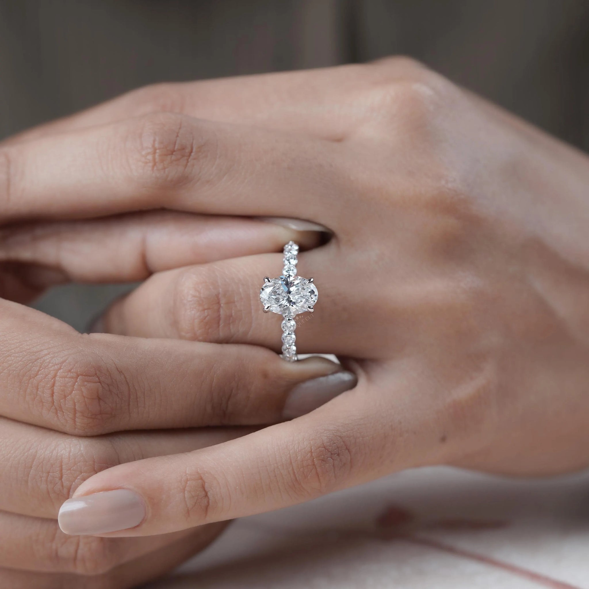 Oval diamond engagement ring with pave band
