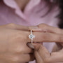 Rose gold pear diamond engagement ring with side stones