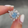 Blue Radiant Diamond Ring with Pear Shaped Halo Accents