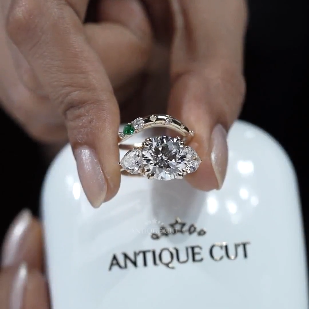 Three stone round diamond ring with heart diamond side stones