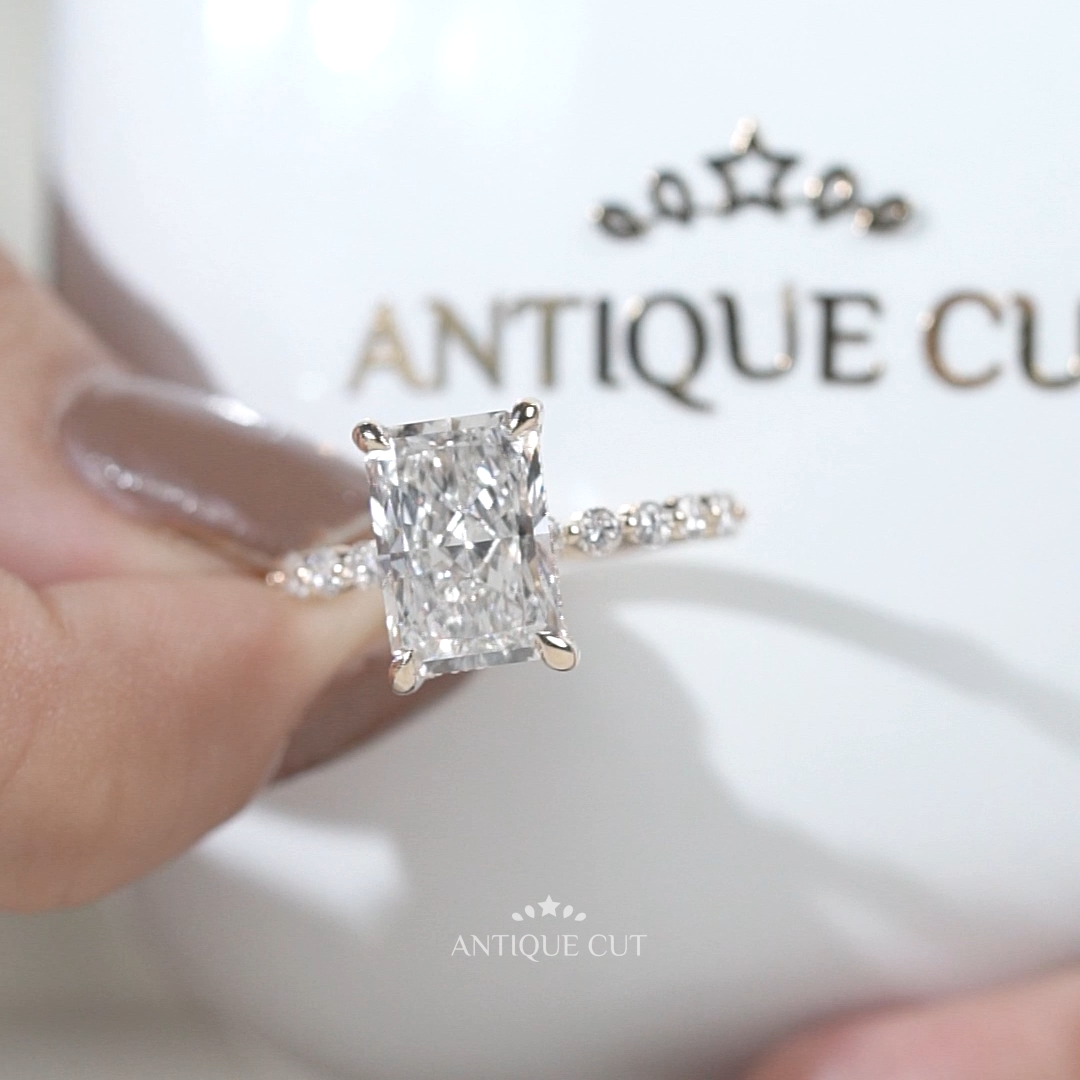 Yellow gold radiant cut engagement ring with hidden halo and pavé diamond band