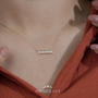 This Yellow gold diamond bar necklace shines beautifully.